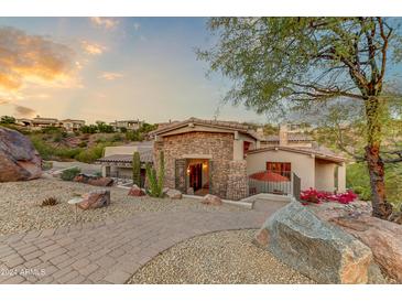 Stunning stone house with a landscaped front yard, walkway, and mountain views at 9749 N Fireridge Trl, Fountain Hills, AZ 85268