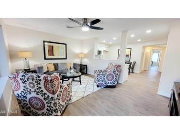 Bright living room with comfy seating and a view into the kitchen at 2064 S Farnsworth Dr # 18, Mesa, AZ 85209