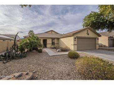 One-story house with desert landscaping, two-car garage, and walkway at 2665 W Goldmine Mountain Dr, San Tan Valley, AZ 85144