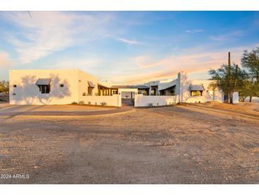 Exterior view of a beautiful home with stucco walls and a metal roof at 29441 N 64Th St, Cave Creek, AZ 85331