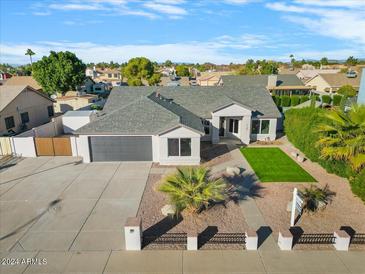 Single-story home with a large backyard, pool, and two-car garage at 7740 W Calavar Rd, Peoria, AZ 85381