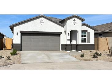 One-story home with gray garage door and desert landscaping at 40030 W Venture Rd, Maricopa, AZ 85138