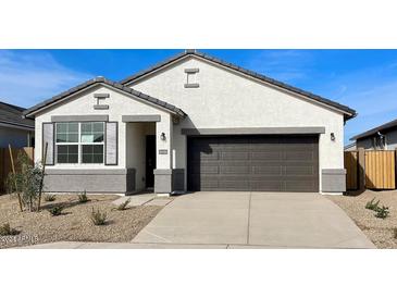 New single-story home with a two-car garage and desert landscaping at 40080 W Venture Rd, Maricopa, AZ 85138