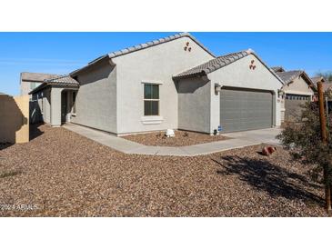 Single-story home with a two-car garage and desert landscaping at 738 W Jardin Dr, Casa Grande, AZ 85122