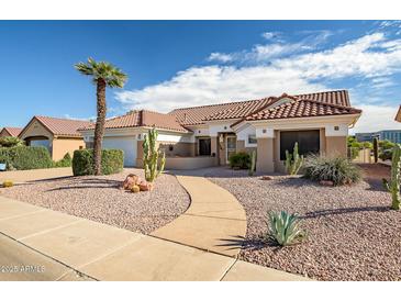 Single-story home with desert landscaping and a paved walkway at 19807 N White Rock Dr, Sun City West, AZ 85375