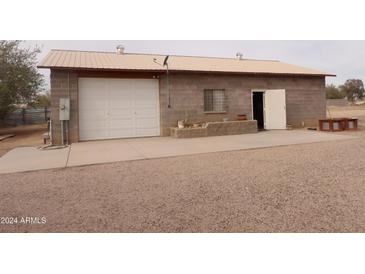 Detached garage with concrete slab and storage area at 30138 W Roosevelt St, Buckeye, AZ 85396