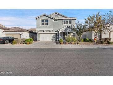 Two-story house with gray siding, two-car garage, and landscaping at 9814 E Palladium Dr, Mesa, AZ 85212