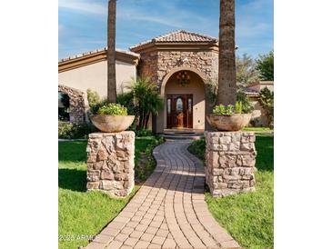 Inviting front entrance with stone accents and a landscaped walkway at 4528 E Hobart St, Mesa, AZ 85205