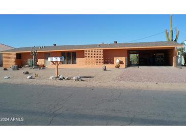 Ranch style home with carport and desert landscaping at 1344 E Victoria View St, Queen Valley, AZ 85118