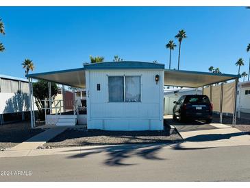 Mobile home exterior with carport and landscaping at 305 S Val Vista Dr # 204, Mesa, AZ 85204