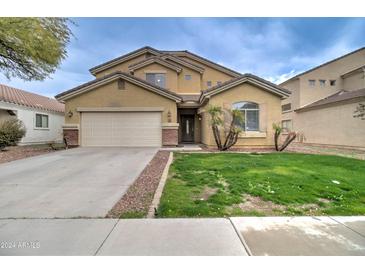 Two-story house with a large yard, driveway, and attached garage at 5659 S 239Th Dr, Buckeye, AZ 85326