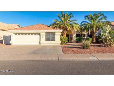 Single-story home with a two-car garage and desert landscaping at 6722 W Piute Ave, Glendale, AZ 85308