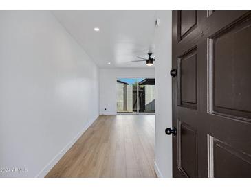 Bright living room with hardwood floors and sliding glass door at 2415 N 71St St # D, Scottsdale, AZ 85257