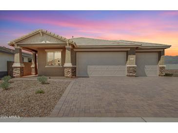 Single-story home with two-car garage and landscaped front yard at 6404 N 190Th Dr, Waddell, AZ 85355