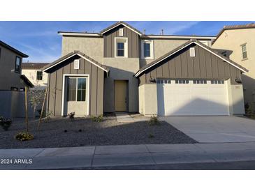 Two-story home with gray siding, a white door, and a two-car garage at 9242 E Sector Dr, Mesa, AZ 85212