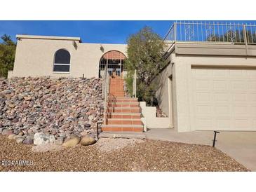 Spanish-style home with tile stairs and a two-car garage at 15326 E Mustang Dr, Fountain Hills, AZ 85268