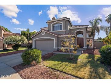 Two-story house with gray exterior, landscaping, and a two-car garage at 21625 N 59Th Dr, Glendale, AZ 85308