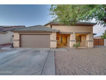 Single-story house with a two-car garage and desert landscaping at 10776 W Encanto Blvd, Avondale, AZ 85392