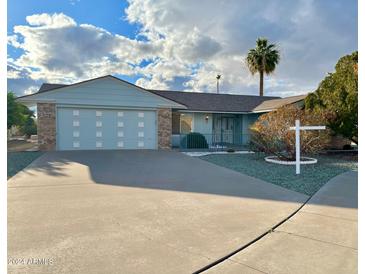 Ranch style home with a two-car garage and well-maintained landscaping at 16828 N 107Th Dr, Sun City, AZ 85351