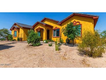 Charming yellow house with landscaped yard at 37547 W Washington St, Tonopah, AZ 85354