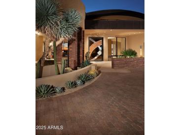 Modern entry with a unique door and beautiful landscaping at 11271 E Cinder Cone Trl, Scottsdale, AZ 85262