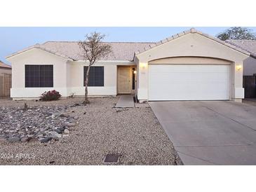 One-story house with a two-car garage and landscaped front yard at 2535 N 87Th Ave, Phoenix, AZ 85037