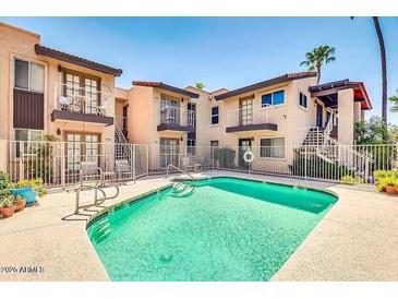 Community pool with patio and surrounding apartments at 7502 E Carefree Dr # 204, Carefree, AZ 85377