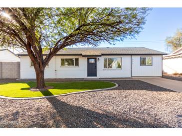 Charming single-story home with a well-manicured lawn and a gray driveway at 331 E Pierce St, Tempe, AZ 85288