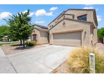 Two-story house with a large driveway and landscaping at 5677 S 239Th Dr, Buckeye, AZ 85326