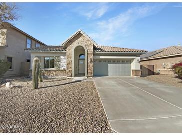 Single-story home with stone accents and a two-car garage at 21366 N Denton Dr, Maricopa, AZ 85138