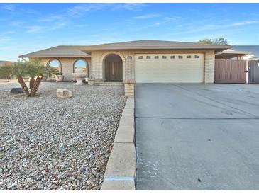 Single story home with two-car garage and desert landscaping at 5221 W Sandra Ter, Glendale, AZ 85306