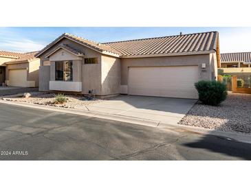 Single story home with two car garage and desert landscaping at 9523 E Placer Dr, Gold Canyon, AZ 85118