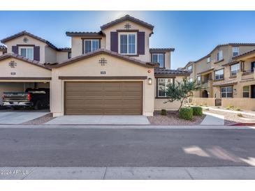 Two-story townhome with attached garage and landscaping at 1255 N Arizona Ave # 1276, Chandler, AZ 85225