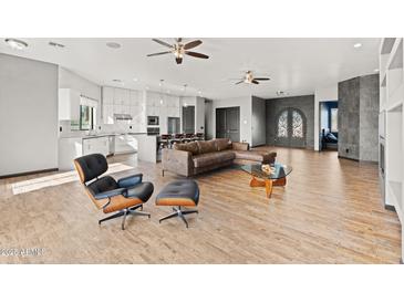 Open living room with modern furniture and hardwood floors at 28919 N 153Rd Ave, Surprise, AZ 85387