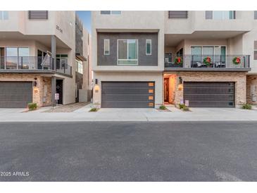Modern townhome exterior with two-car garage and private balcony at 6850 E Mcdowell Rd # 26, Scottsdale, AZ 85257