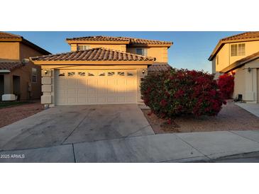 Two-story house with attached garage and landscaping at 11706 W Shaw Butte Dr, El Mirage, AZ 85335