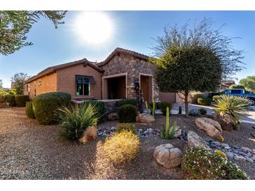 Single-story home with stone accents and landscaped front yard at 26653 W Firehawk Dr, Buckeye, AZ 85396