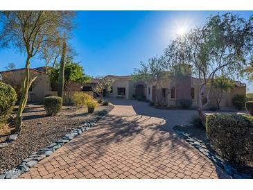 Stunning home exterior with a large courtyard and brick driveway at 5681 E Canyon Ridge North Dr, Cave Creek, AZ 85331