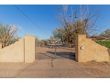 Secluded property with gated entrance and mature landscaping at 1340 W Romley Rd, Phoenix, AZ 85041