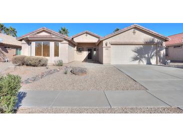 Single-story house with a two-car garage and desert landscaping at 2394 E Fiesta Dr, Casa Grande, AZ 85194