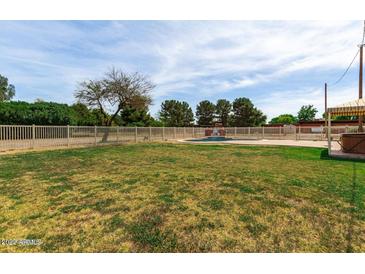 Large backyard with grassy area, pool, and covered patio at 24007 S Lindsay Rd, Chandler, AZ 85249