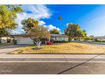 Single story home with landscaped yard and two car garage at 575 Leisure World --, Mesa, AZ 85206
