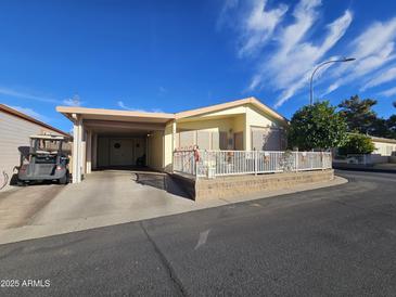 Inviting exterior of a manufactured home with carport and landscaping at 650 N Hawes Rd # 4634, Mesa, AZ 85207