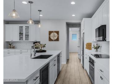 Open concept kitchen with island, stainless steel appliances, and white cabinets at 20865 E Timberline Rd, Queen Creek, AZ 85142