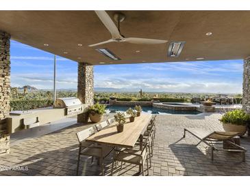 Covered patio with built-in grill, dining table, and stunning views at 5630 E Rockridge Rd, Phoenix, AZ 85018