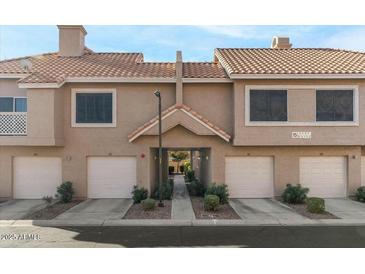 Tan two-story building with several units, featuring garages and landscaping at 1633 E Lakeside Dr # 113, Gilbert, AZ 85234