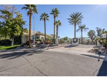 gated community entrance with palm trees at 7777 E 2Nd St # 111, Scottsdale, AZ 85251
