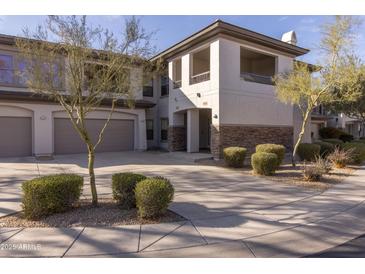 Two-story condo building with attached garage and landscaping at 33550 N Dove Lakes Dr # 2026, Cave Creek, AZ 85331