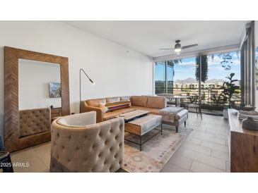 Bright living room with leather sofa and city views at 7180 E Kierland Blvd # 414, Scottsdale, AZ 85254