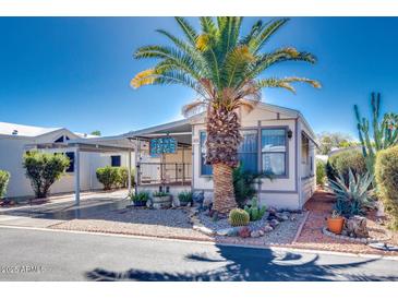 Single-wide manufactured home with carport and desert landscaping at 17200 W Bell Rd # 64, Surprise, AZ 85374